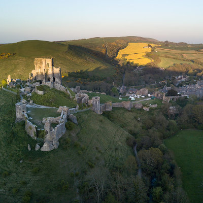 Sun setting over Corfe Castle, looking along the purbeck hills