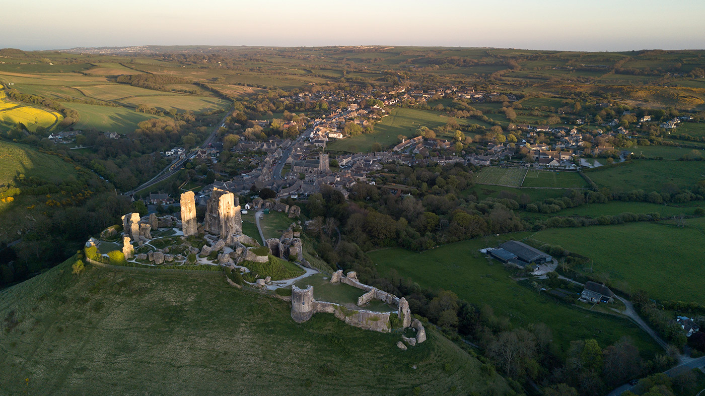 Sun setting over Corfe Castle, looking along the purbeck hills